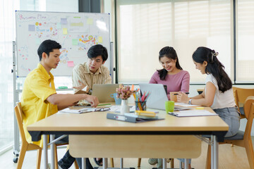 Group Young Asian business people with the creative work, talk and exchange ideas shared at the meeting.