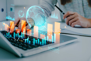 Businesswoman wearing casual wear typing on laptop sitting at office