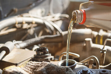 Refueling and pouring oil quality into the engine motor car Transmission and Maintenance Gear .Energy fuel concept.