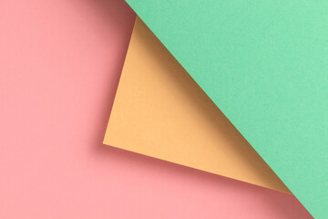 Paper background with yellow, turquoise and pink pastel colors.