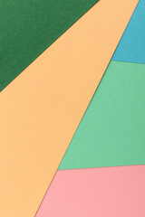 Paper background with green, blue, turquoise, yellow and pink pastel colors.