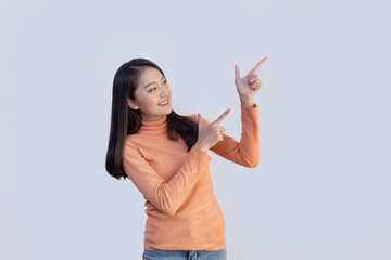 Asian Woman Pointing to Blank Space