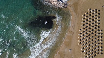 umbrellas on the beach from above in Crete