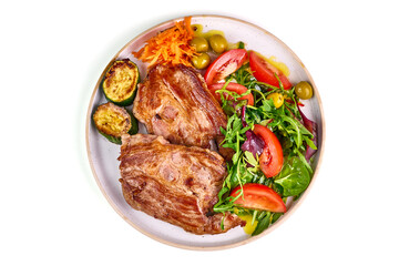 Grilled pork steaks with vegetable salad, isolated on white background.