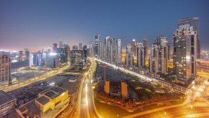 Bay Avenue with modern towers residential development in Business Bay aerial panoramic night to day timelapse, Dubai