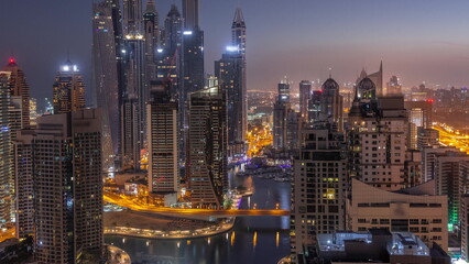 Fototapeta na wymiar View of various skyscrapers in tallest recidential block in Dubai Marina aerial night to day timelapse
