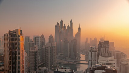 View of various skyscrapers in tallest recidential block in Dubai Marina aerial timelapse