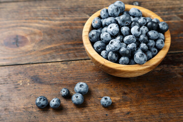 Fresh blueberries in a wooden bowl