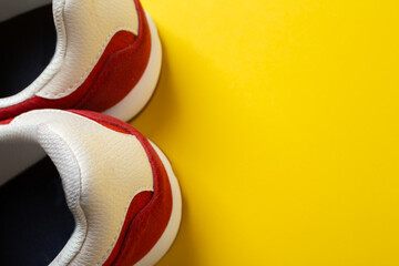 New red sneakers on a yellow background. space for text.