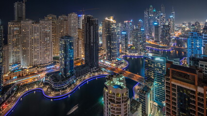 Fototapeta na wymiar Panorama showing various skyscrapers in tallest recidential block in Dubai Marina aerial night timelapse