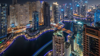 View of various skyscrapers in tallest recidential block in Dubai Marina aerial night timelapse