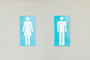 Men and women toilet rest room sign on the wall.