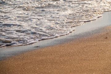 Soft wave of the sea on the sandy beach.