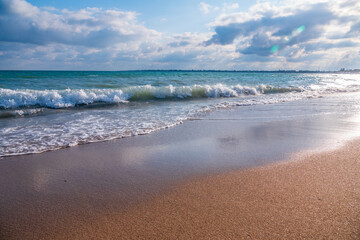 Soft wave of the sea on the sandy beach.
