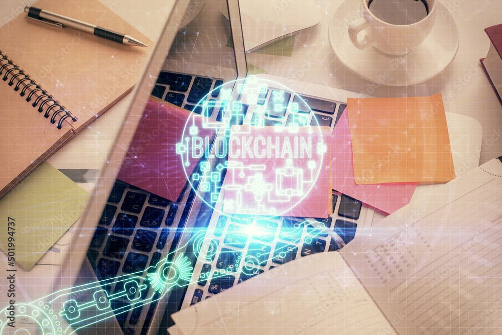 Poster Blockchain theme hologram drawings over computer on the desktop background. Top view. Multi exposure. Concept of cryptoeconomy.