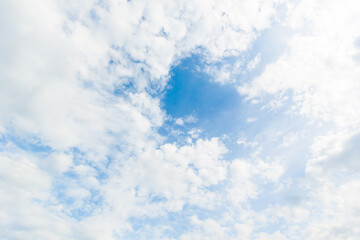 blue sky background with white clouds cumulus floating soft focus.