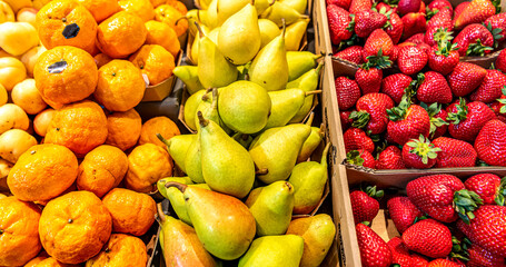 Fruit market. Strawberries, pears and tangerines on the counter