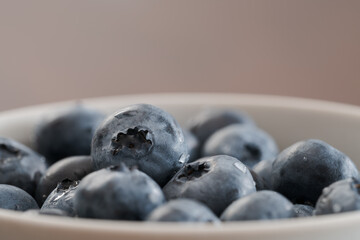 Fresh washed blueberries in white bowl closeup