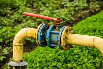 old yellow gas pipe with blue valve