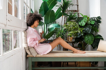 Beautiful latino woman with curly hair at home