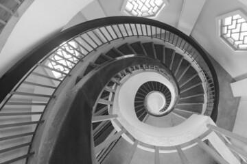 Spiral staircase resembling a fibonacci spiral with high contrast black, white, and gray shades - 501999197