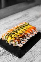 Sushi Set nigiri and sushi rolls on black stone slate plate board top view