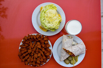 Cig kofte (raw meatball in Turkish) with lettuce, tomato, pickle and lemon, hot Chee kofta. Turkish local raw food concept.
Table scene of assorted take out or delivery foods.Top view of assorted Turk