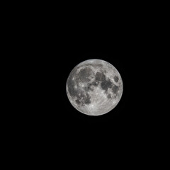 Naklejka na ściany i meble Detailed image of the full moon isolated on black.