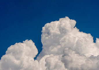 Naklejka na ściany i meble White fluffy big clouds against sky