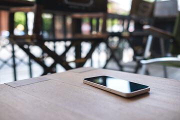A single mobile phone on wooden table
