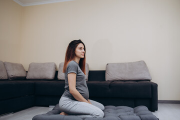 Obraz premium Pregnant Woman Stretching Arms And Legs, Doing Prenatal Workout At Home On Yoga Mat. Selective focus