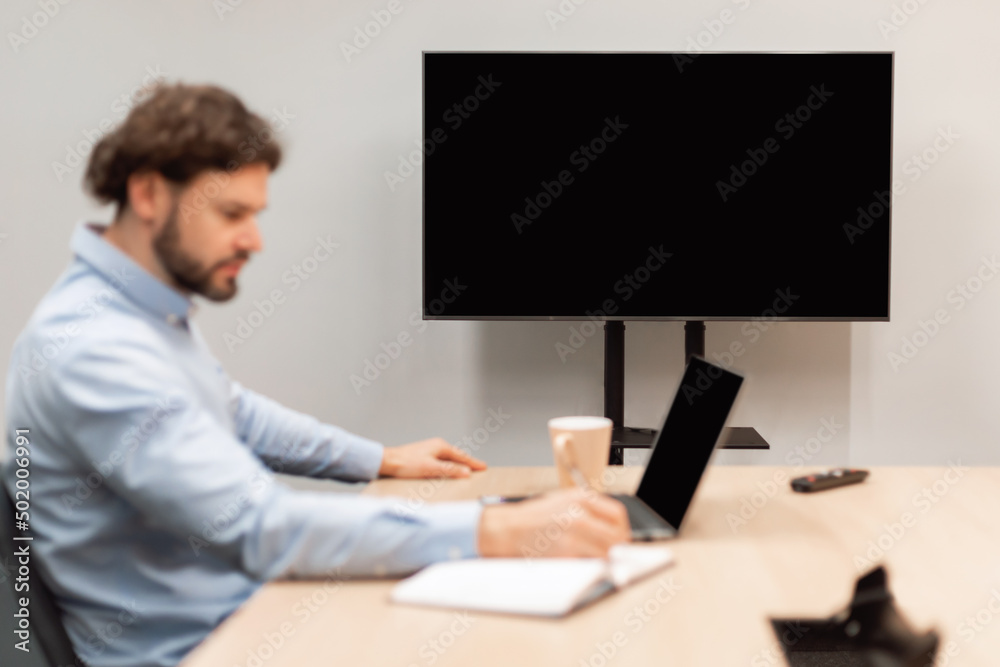 Poster worker watching webinar, focus on monitor with black empty screen,
