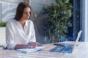 Attractive businesswoman in white shirt at workplace working with laptop to optimize development by...
