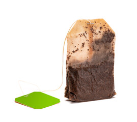Teabag with green label. Isolated on a white. Tea.