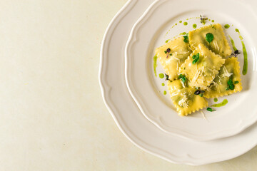 Ravioli with spinach and cheese, green sauce, on a light background, selective focus, no people,