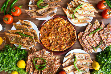  Traditional Turkish cuisine. Pizza, pita, pidesi, sucuk, hummus, kebab. Many dishes on the table. Serving dishes in restaurant. Background image. Top view, flat lay