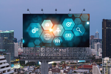 Hologram of Research and Development glowing icons on billboard. Sunset panoramic city view of Bangkok. Concept of innovative technologies to create new services and products in Southeast Asia.