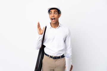 African American architect man with helmet and holding blueprints over isolated white background _ with surprise facial expression