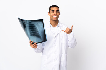 African American traumatologist over isolated whitebackground making phone gesture