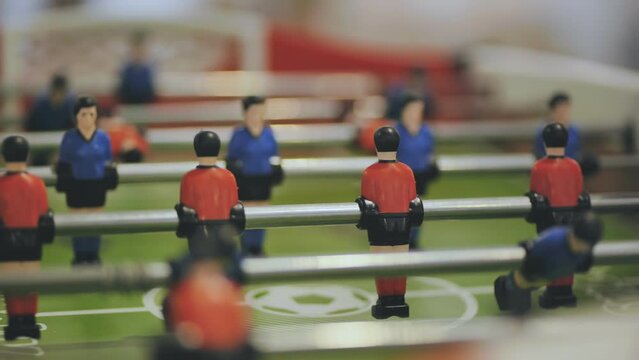 Players play table football in the clubhouse.