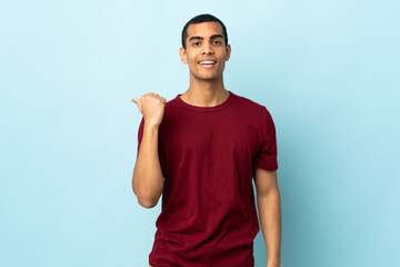African American man over isolated background pointing to the side to present a product