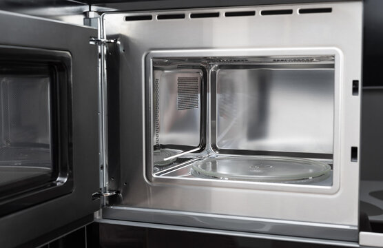 new clean stainless microwave built in with grill. modern kitchen appliance. selective focus © Mila Naumova