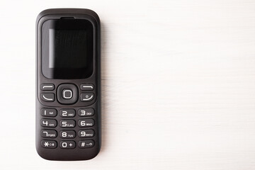 button cellphone, mobile phone, handset, cheap disposable device