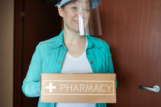 Pharmacy Courier With A Box Of Medicines Stands Near The Door, Medical Delivery, A Volunteer For The Elderly