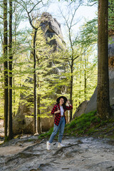 Fototapeta na wymiar woman hiker with backpack walking by forest trail