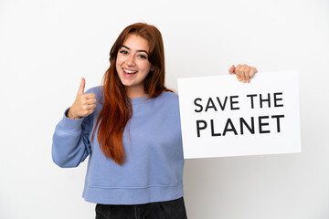 Young redhead woman isolated on white background holding a placard with text Save the Planet with thumb up