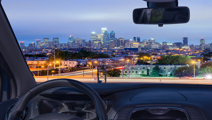 Car windshield with view of Philadelphia skyline at night, USA
