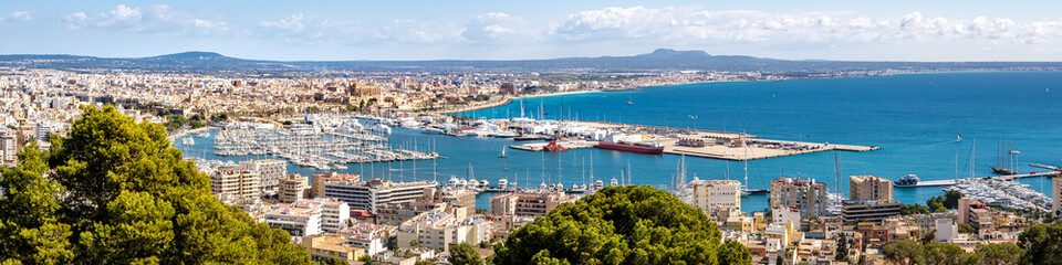 Fototapeta na wymiar Panorama view from elevated castle Castell de Bellver over the bay of Palma de Mallorca with old town, cathedral La Seu, marina, harbor to the airport and famous beach Platja de Palma at the horizon.