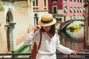 young pretty woman traveler standing at venice bridge cross canal