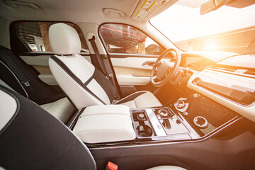 Modern luxury prestige car interior, dashboard, steering wheel. Orange red car interior.